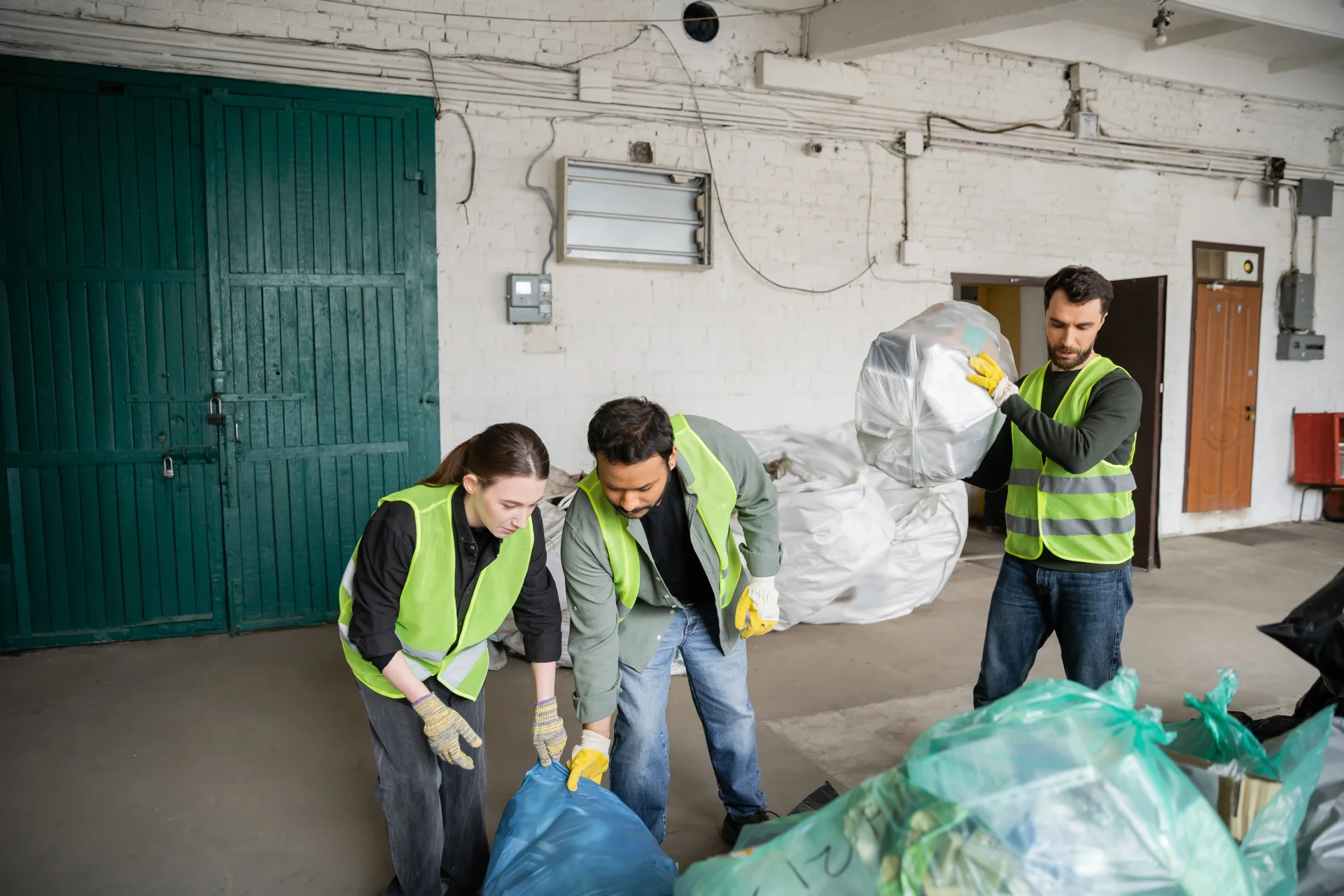 multiethnic-workers-in-protective-vests-and-gloves
