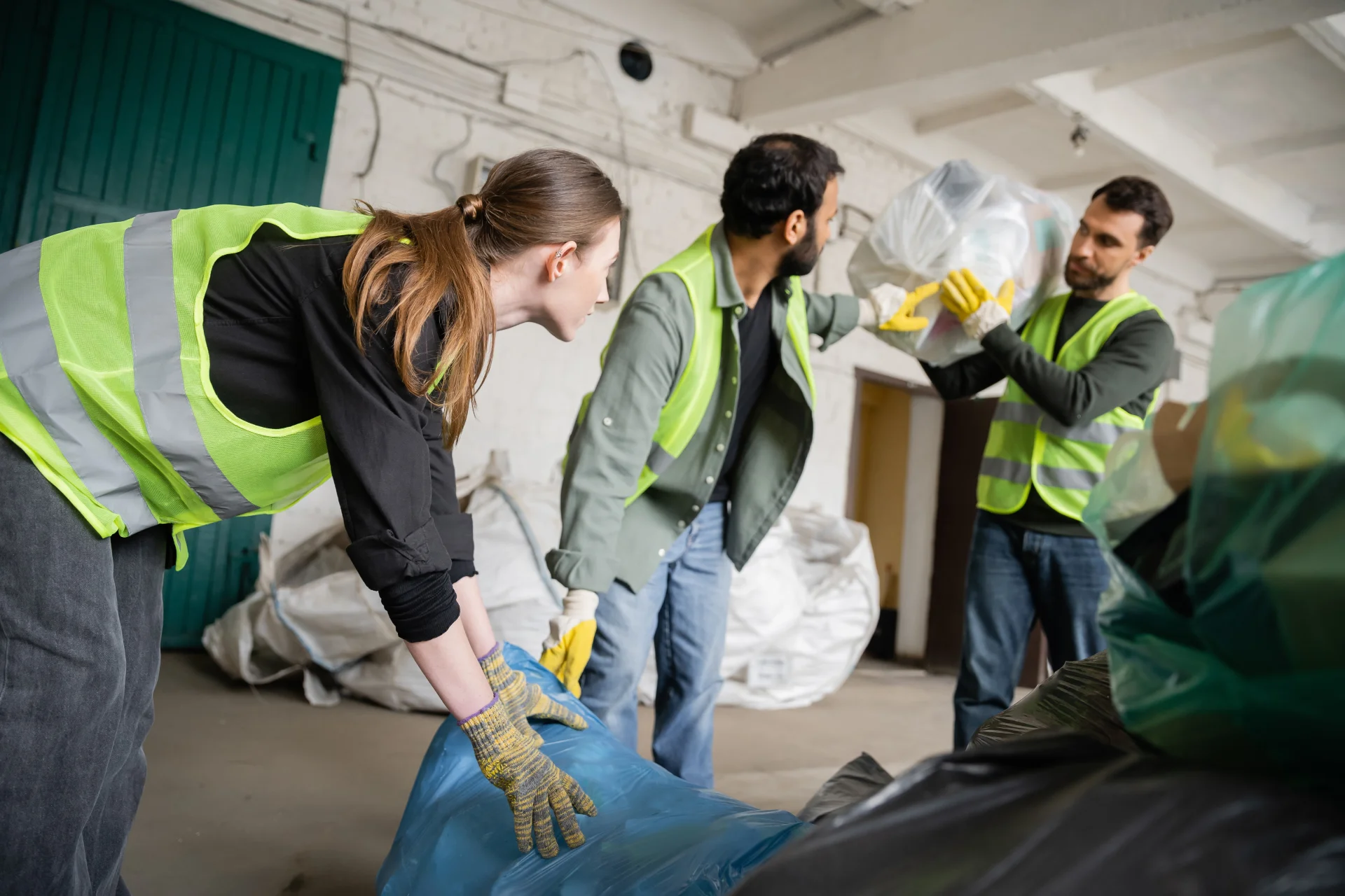 young-female-worker-in-protective-vest-and-gloves